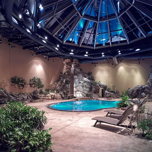 An image of the pool area highlighting the lounges and the waterfall.