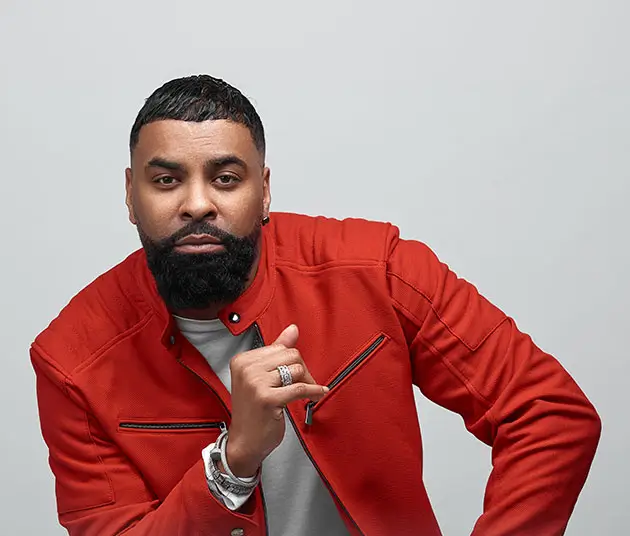 A picture of GInuwine in a red jacket and white shirt.